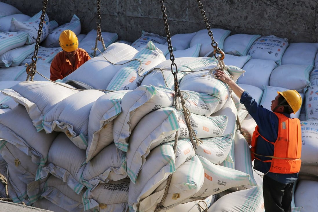 Bags of imported soybean meal are handled at a port in China’s Jiangsu province. Photo: AFP