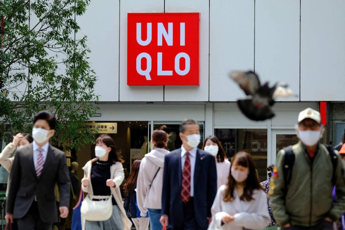 Passers-by walk past a Uniqlo store in Tokyo. Photo: EPA-EFE