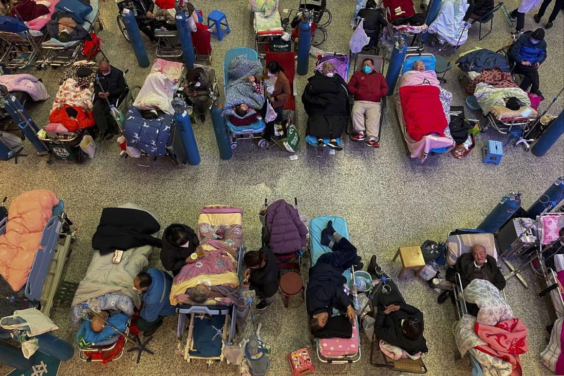People take care of elderly relatives lying on stretchers at the Changhai Hospital hall in Shanghai on January 3. Photo: AP