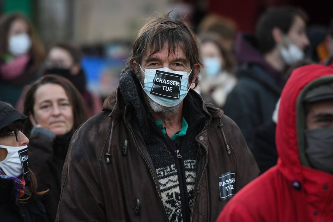 A protester wears a facemask reading “hunting kills” during a march in France held to pay tribute to Morgan Keane after he was killed by a hunter. Photo: AFP