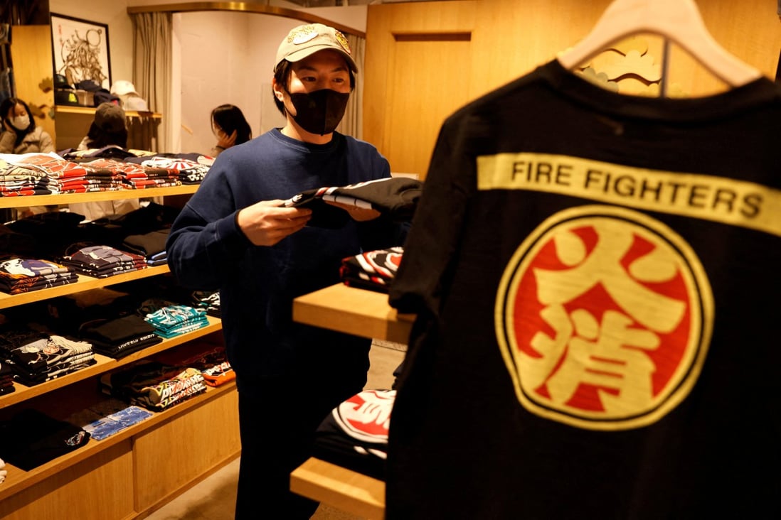 Sales manager Masaki Nagayama works at his store, a clothes shop featuring Japanese firefighter organisation of the Edo era.The Japanese government is considering no longer asking the public to wear masks indoors in principle unless they have symptoms. Photo: Reuters