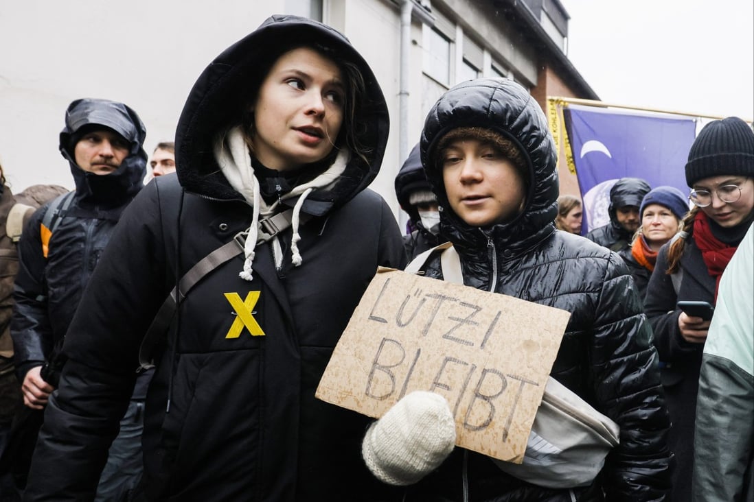Swedish climate activist Greta Thunberg (right) holding a placard reading “Luetzi stays” is joined by  German climate activist Luisa Neubauer (left) as they attend a rally of climate protection activists near the village of Luetzerath in Germany on January 14, 2023. Photo: EPA-EFE
