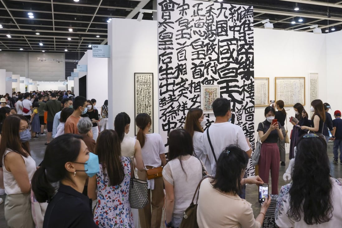 Visitors admire graffiti calligraphy by Tsang Tsou-choi at Art Basel in May last year. The Hong Kong government has formed a new Arts and Cultural Events Committee to bring cultural events back to the city. Photo: Nora Tam