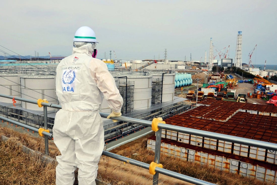 A member of an International Atomic Energy Agency inspection team looks out over the Fukushima Daiichi Nuclear Power Station. Japan has approved release of more than 1 million tonnes of water from the destroyed power plant. Photo: International Atomic Energy Agency Handout via AFP