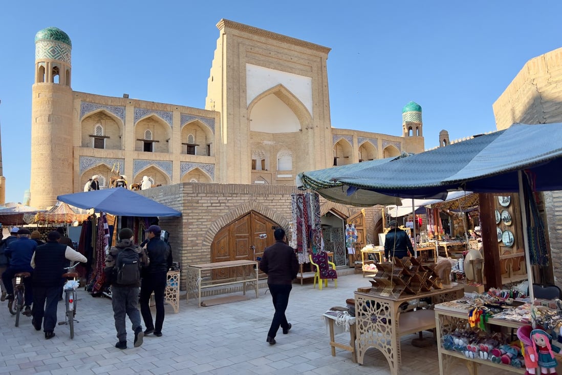 The warren of well-preserved streets in Uzbekistan’s ancient city of Khiva that weave between mosques and madrasas also function as a vast open-air souvenir market. Photo: Peter Neville-Hadley