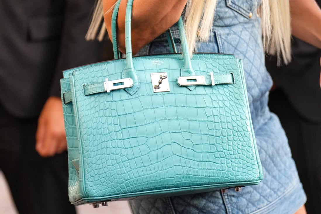 A guest carries a blue crocodile skin Birkin handbag from Hermès during the Cannes Film Festival in 2022. Demand for exotic skin bags remains strong even as some brands move away from them. Photo: GC Images