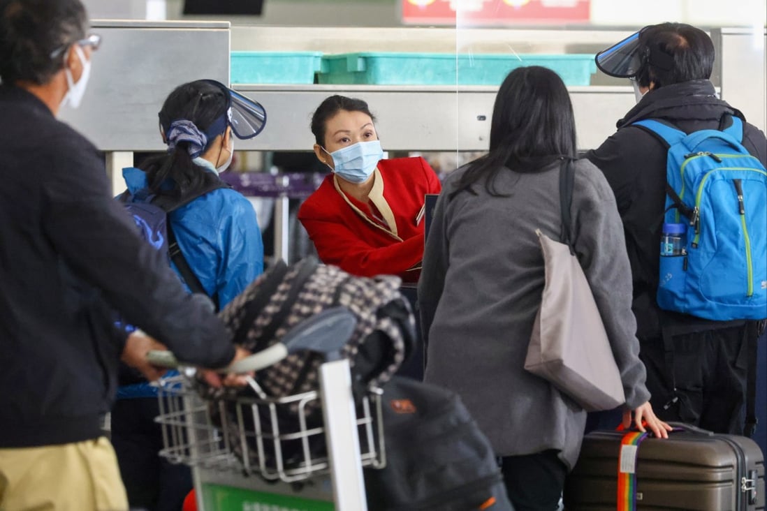 A Cathay employee helps passengers at Hong Kong International Airport. Photo: Dickson Lee