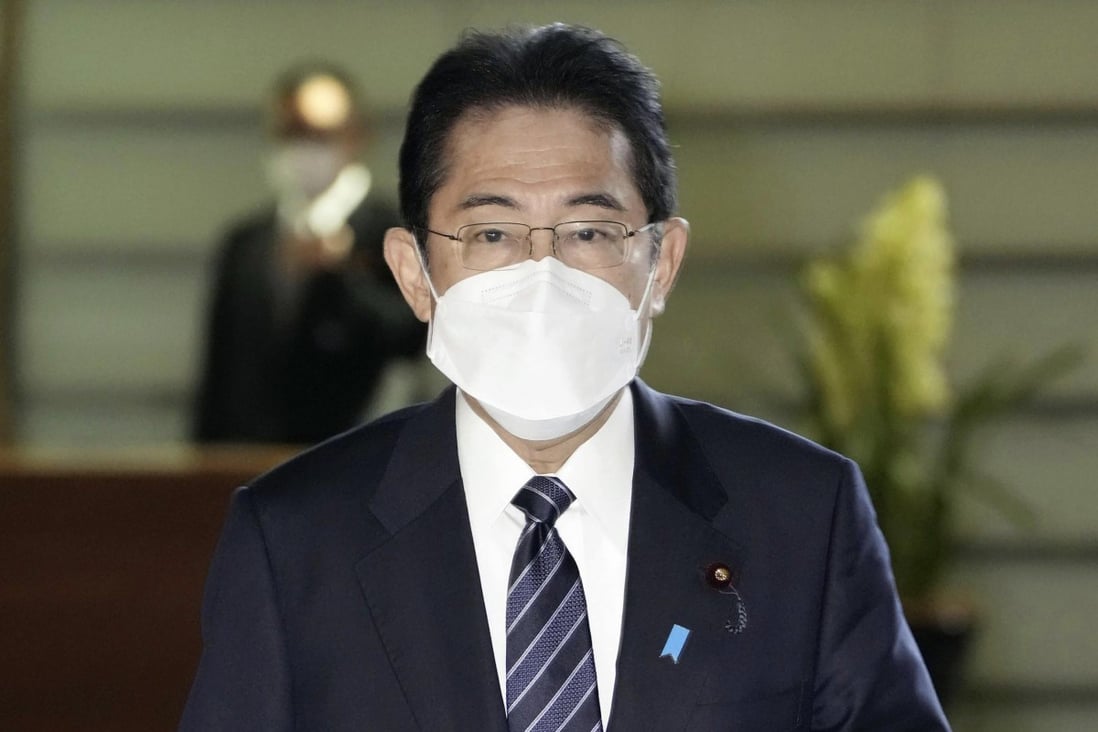 Japan’s Prime Minister Fumio Kishida arrives at his office in Tokyo Friday to announce preparations for downgrading the legal status of Covid-19. Photo: AP