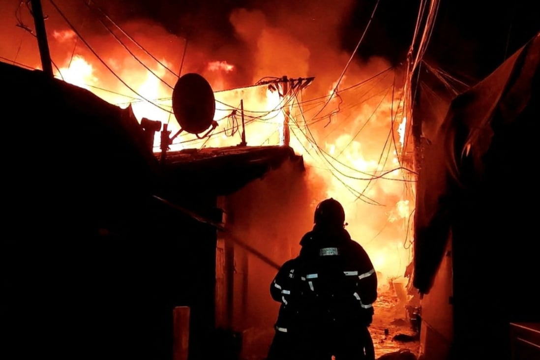 Firefighters work to extinguish the blaze at Guryong village, the last slum in Seoul’s glitzy Gangnam district, on Friday morning. Photo: South Korea’s National Fire Agency/Yonhap via Reuters