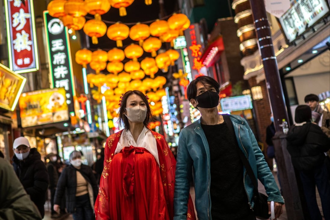 People walk underneath lanterns in the Chinatown section of Yokohama, south of Tokyo, on January 15, 2023, ahead of the Lunar New Year. Photo: AFP