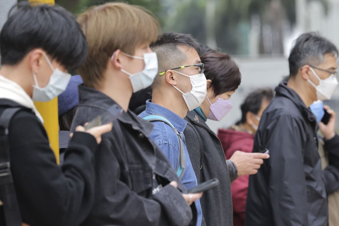 Hong Kong pedestrians in masks in Tsim Sha Tsui. The city is aiming to lift all Covid curbs by this year. Photo: Jelly Tse