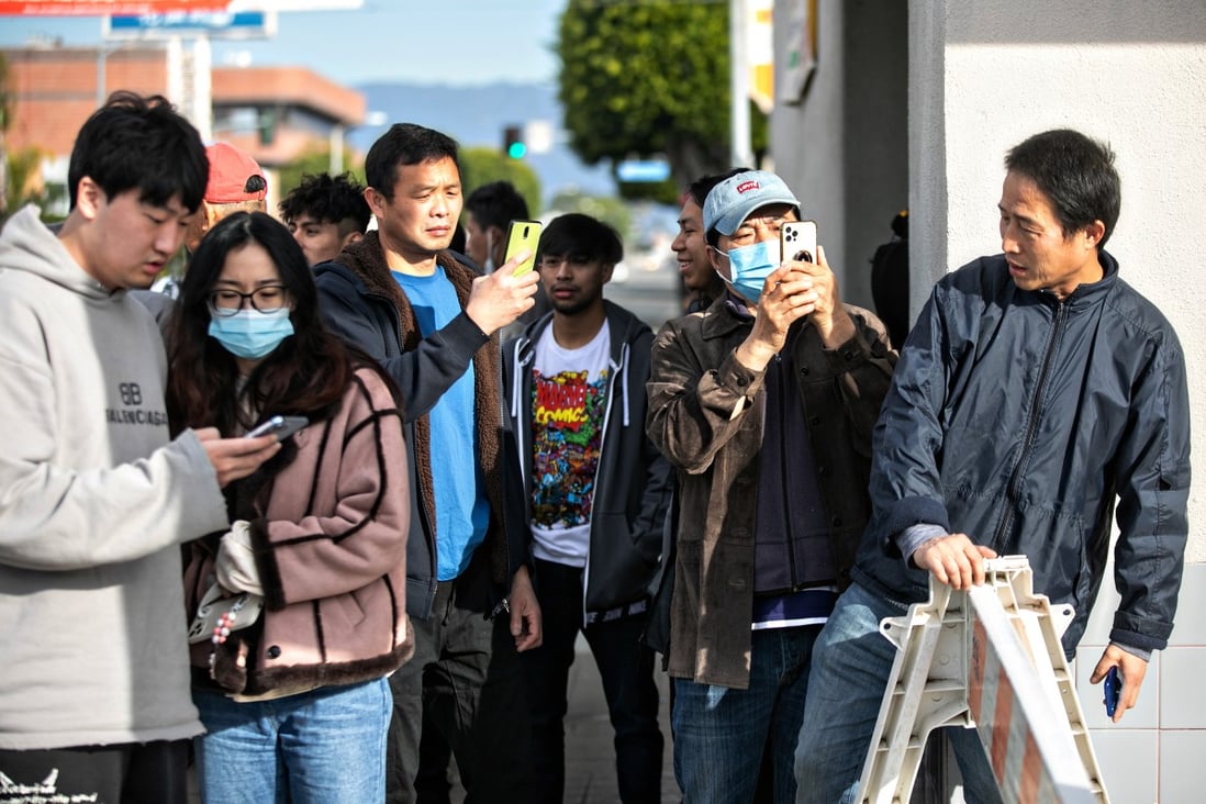 Community members watch as officials  investigate the scene where a gunman opened fire at a ballroom dance studio in Monterey Park, California. Photo: TNS