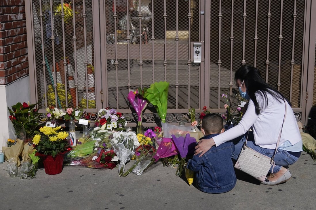 A woman comforts her son while visiting a makeshift memorial outside Star Ballroom Dance Studio in Monterey Park, California, on Monday. Photo: AP