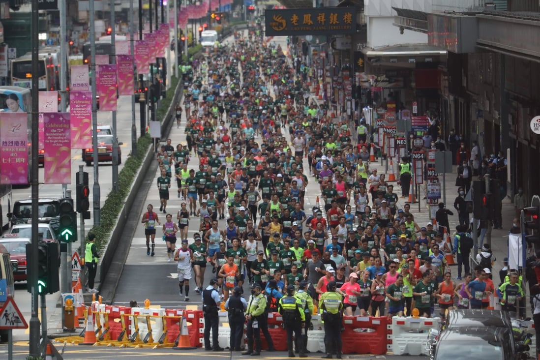 Participants run through Nathan Road in Mong Kok during the 2021 Standard Chartered Hong Kong Marathon. Photo: Winson Wong