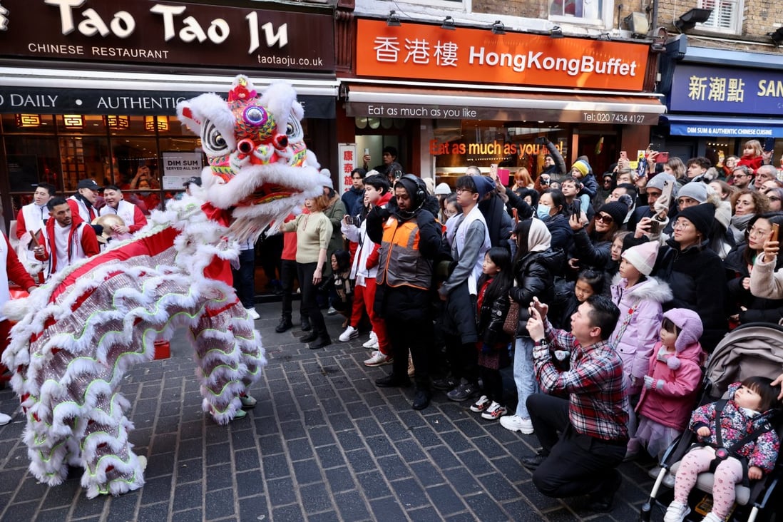 A lion dance is performed in the streets of Chinatown for the Chinese Lunar New Year in London. Photo: Reuters