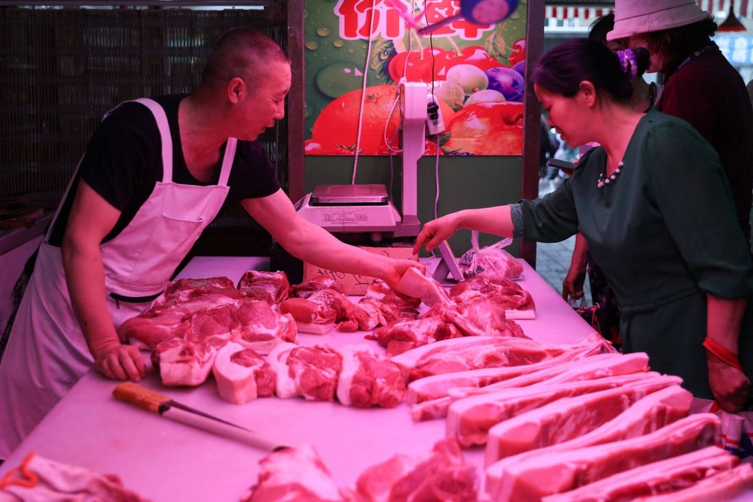 A customer buys meat at a market in Shenyang, China’s northeastern Liaoning province. Rising affluence in Asia is driving demand for meat. Photo: AFP