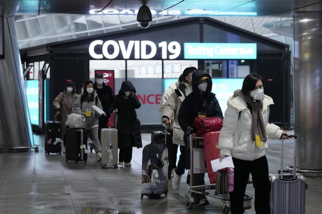 Passengers arriving from China pass by a Covid testing centre at Incheon airport in South Korea on January 14. Photo: AP
