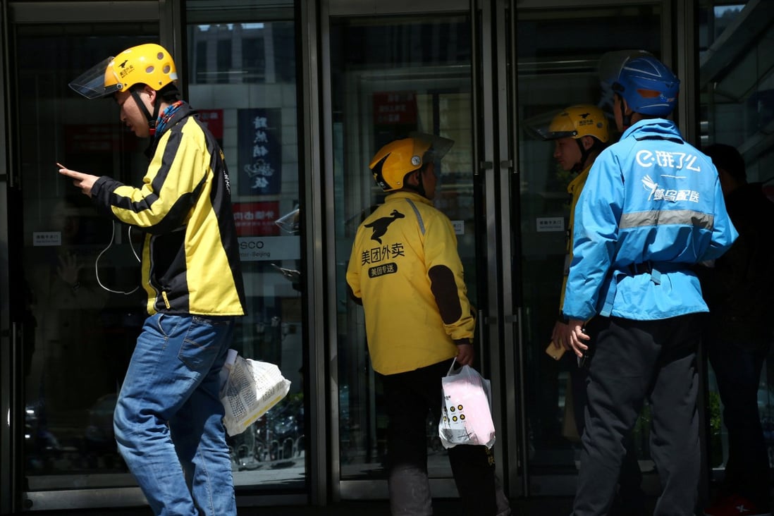 Drivers of food delivery service Ele.me (in blue) and Meituan (in yellow) seen in Beijing on April 11, 2018. Photo: Reuters