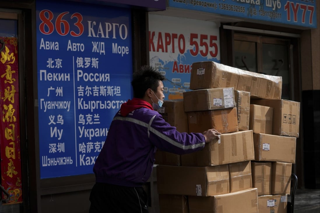 A delivery worker pushes packages through an area known as the Russian Market in Beijing. Mainland China and Hong Kong are said to have supplied around 40 per cent of Russia’s total computer chips last year. Photo: AP