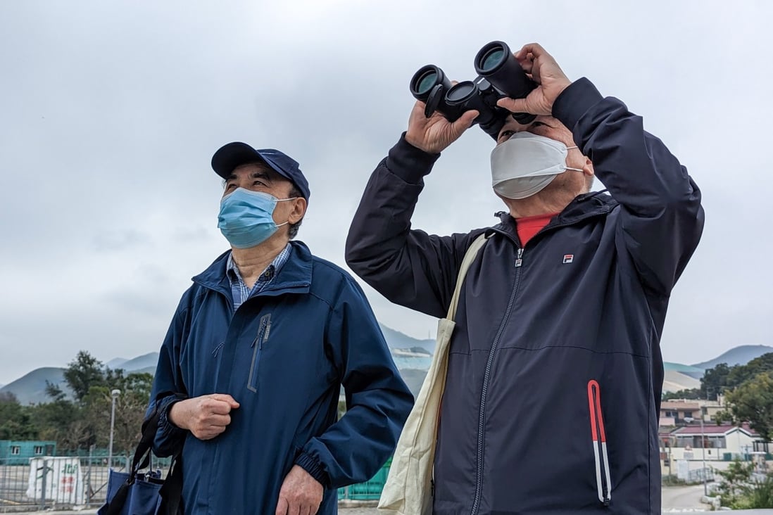 Lim Kian-sang (with binoculars) , 69, travelled with a friend to the border crossing at Heung Yuen Wai, which will open to the public on Monday, to try and spot his wife’s flat just inside mainland China. Photo: Kahon Chan