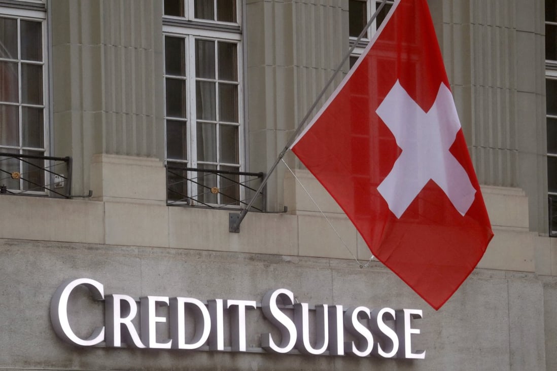 Switzerland’s national flag flies above a logo of Credit Suisse in front of a branch office in Bern, Switzerland, on November 29, 2022. Photo: Reuters