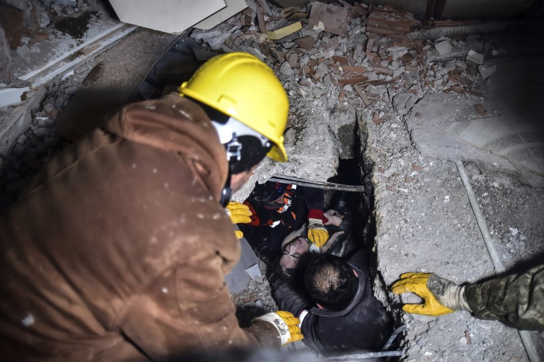Emergency workers and medics rescue a woman out of the debris of a collapsed building in Elbistan, Kahramanmaras, in southern Turkey. Photo: AP
