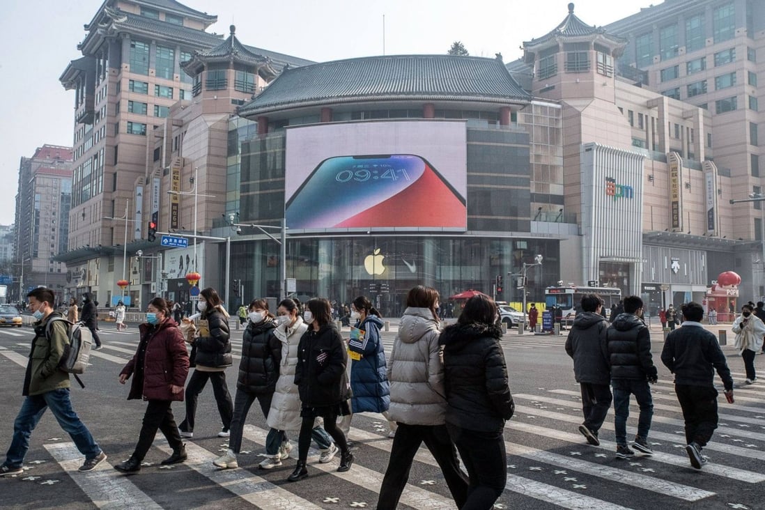 Pedestrians pass an Apple store in the Wangfujing shopping area in Beijing, on February 10. MNCs in China’s big market are having to cope with the souring of Western attitudes towards China, a relatively new and unexpected phenomenon. Photo: Bloomberg