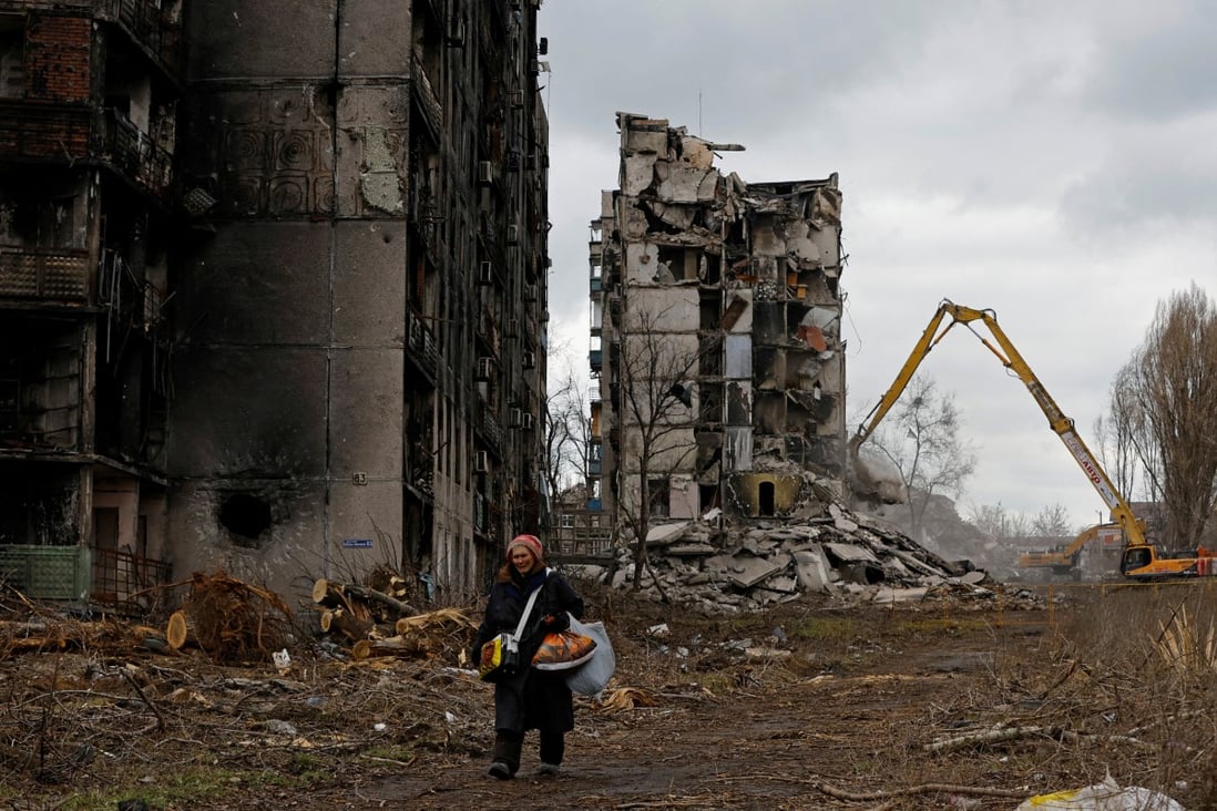 A woman walks past destroyed apartment blocks in her neighbourhood in Mariupol in Russian-controlled Ukraine, on February 15. Photo: Reuters