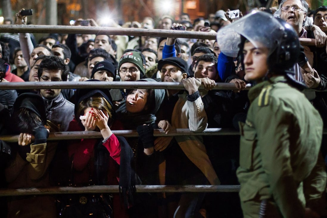 Iranian women react during the execution of two men in Tehran in 2013. File photo: AP