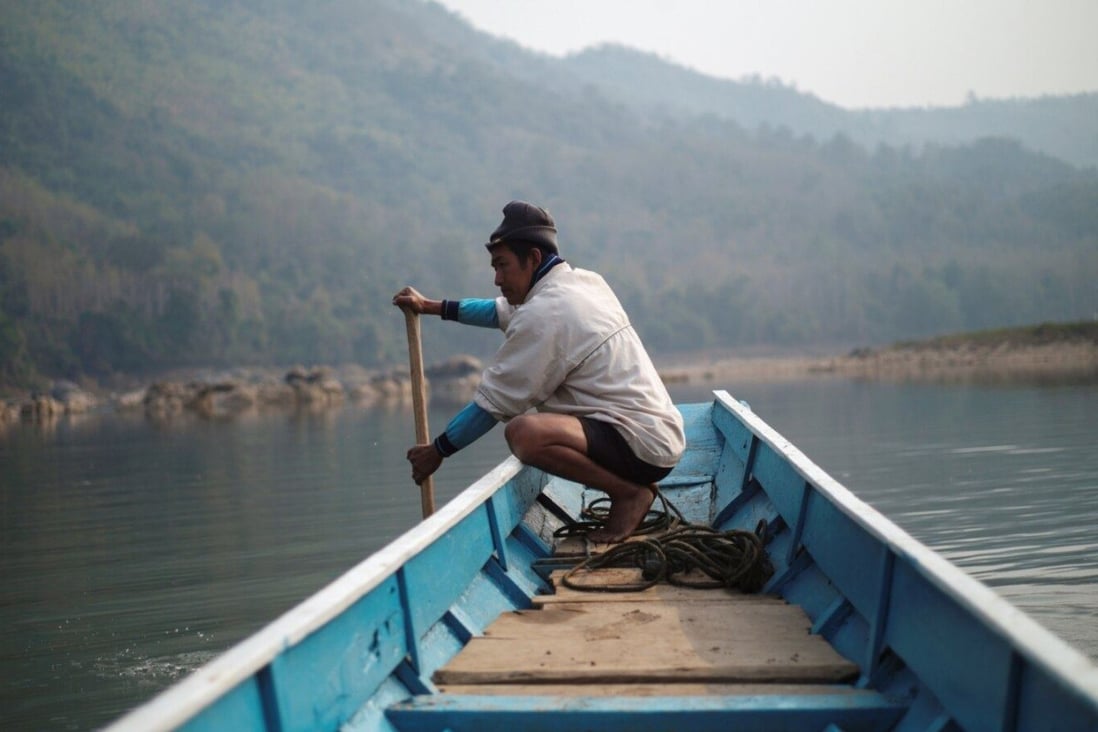 A local villager steers a boat where the future site of the Luang Prabang dam will be on the Mekong River. Photo: Reuters