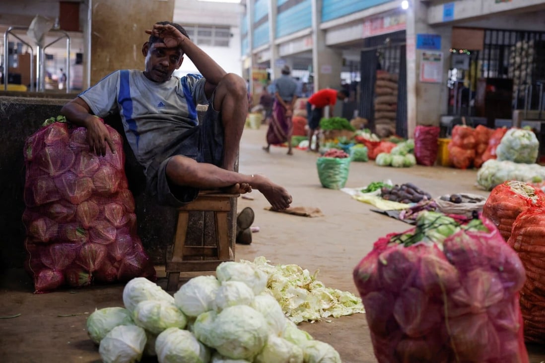 A vendor waits for customers at his vegetable stall at a main market in Colombo, Sri Lanka, in February 2023. Photo: Reuters