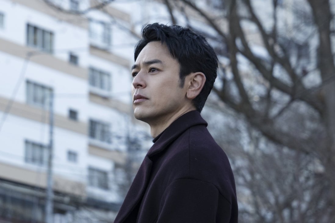 Satoshi Tsumabuki in a still from A Man (category: IIA Japanese), co-starring Sakura Ando and directed by Kei Ishikawa.