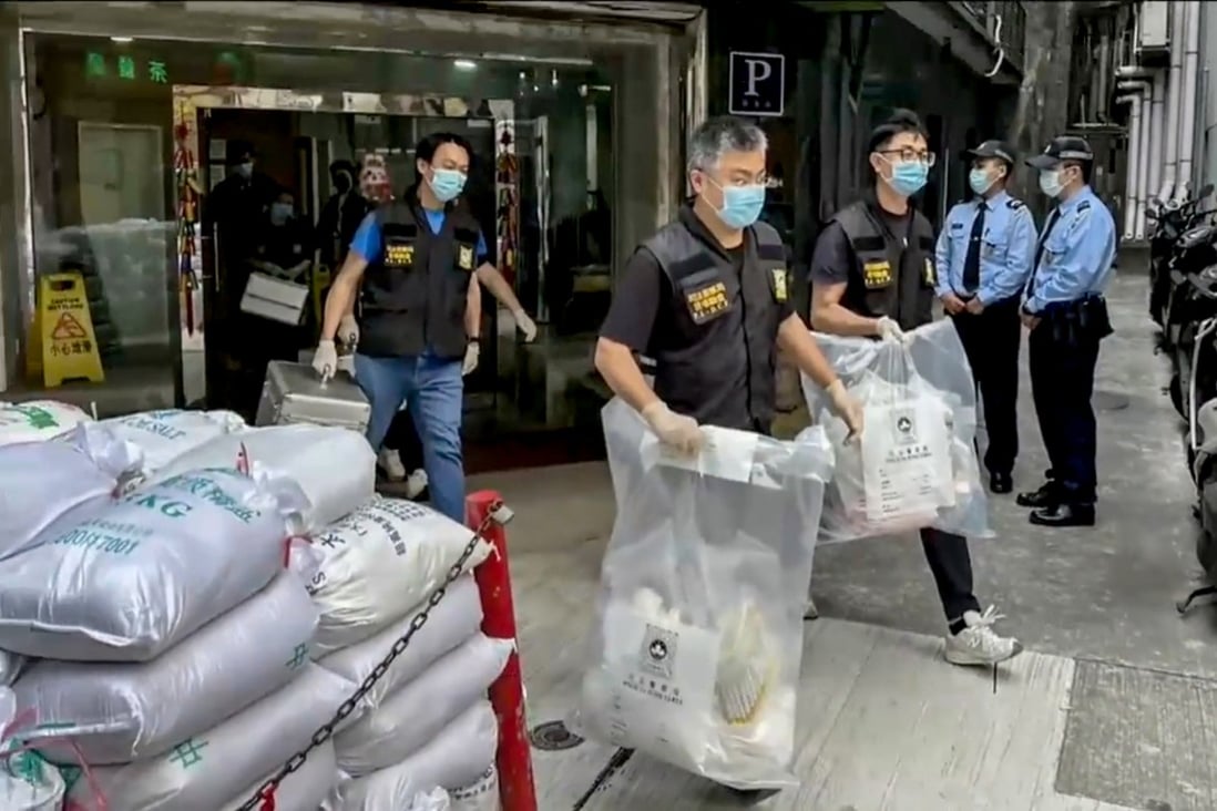 Macau police seize evidence from a hotel room where a woman’s body was found. Photo: Handout
