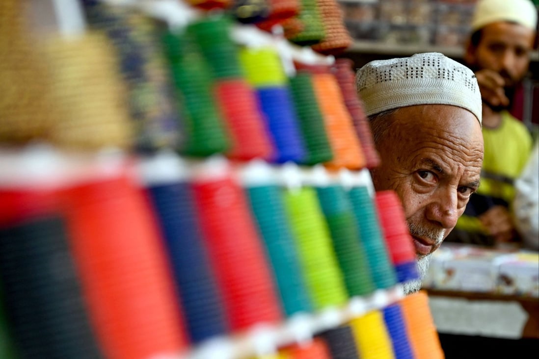 A vendor selling bangles waits for customers at a market in Bulandshahr, Uttar Pradesh, India, on March 11. India is still decades away from realising its true potential. Photo: AFP 