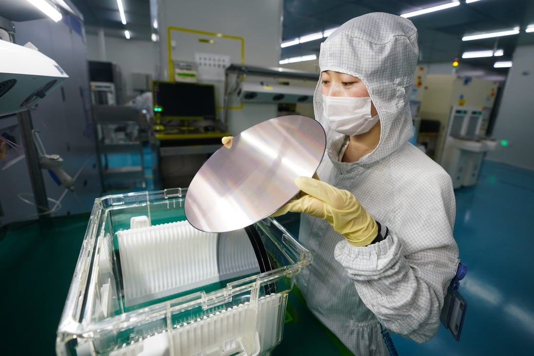 A worker examines a semiconductor wafer at HT-Tech (Nanjing) Co, in east China’s Jiangsu province, March 9, 2023. Photo: Xinhua
