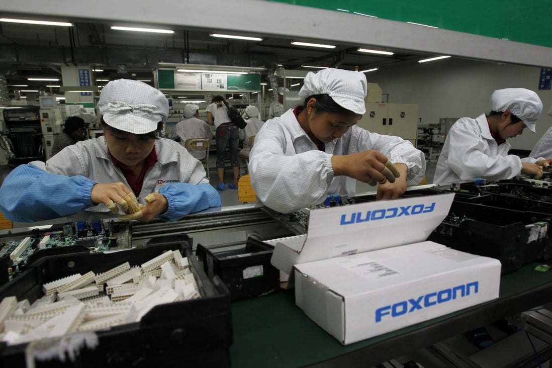 Staff members work on the production line at Foxconn Technology Group’s manufacturing complex in the tech hub of Shenzhen, in southern Guangdong province. Photo: AP