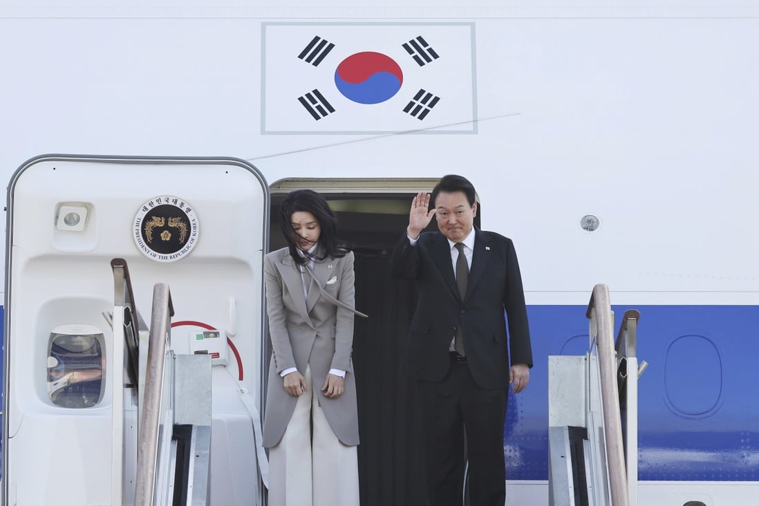 South Korean President Yoon Suk-Yeol waves as his wife Kim Keon-hee bows before departing for Japan at the Seoul military airport in Seongnam. Photo: AP