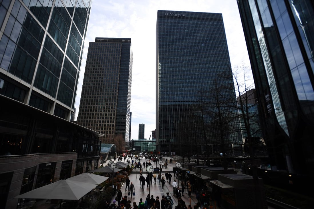 International banks tower over pedestrians in the Canary Wharf financial district, in London, on March 16. Fears are growing of a new global banking crisis following the losses suffered by Credit Suisse and the collapse of US bank SVB. Photo: EPA-EFE