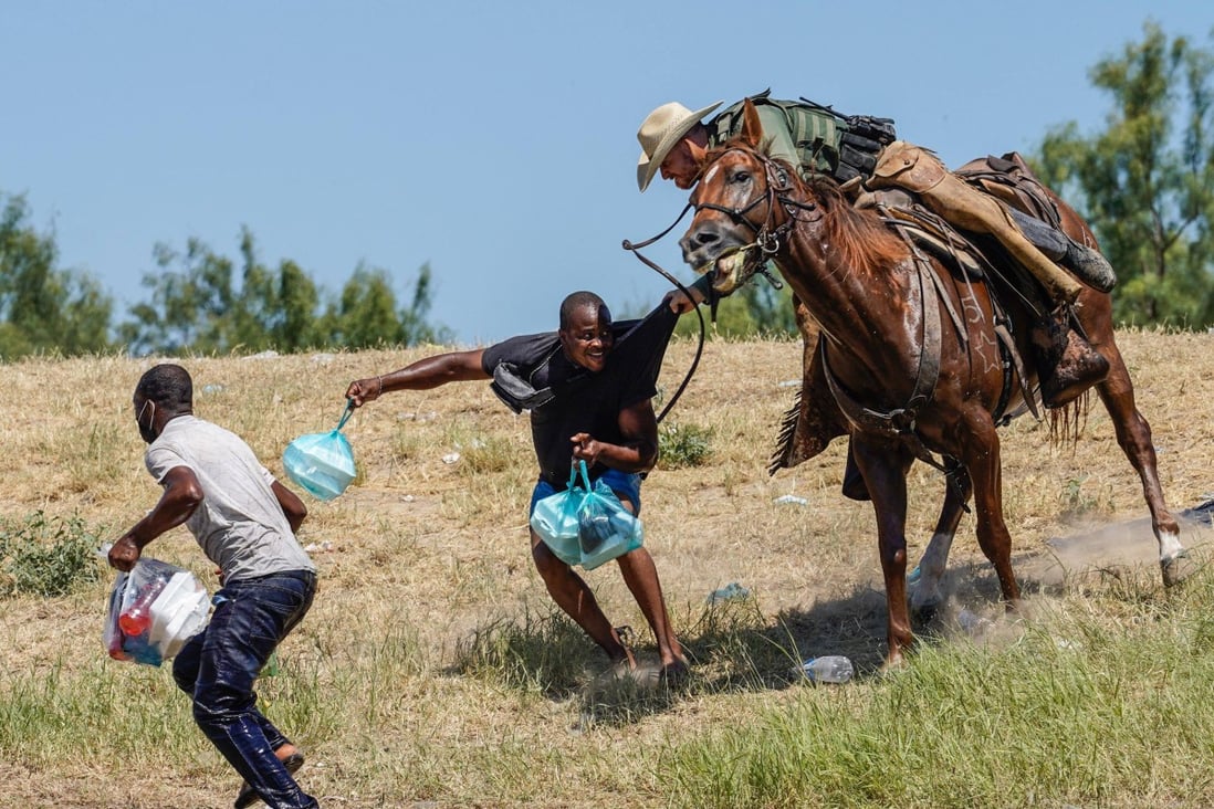 A US Border Patrol agent on horseback tries to stop a Haitian migrant from entering an encampment on the banks of the Rio Grande, Texas in 2021. File photo: AFP
