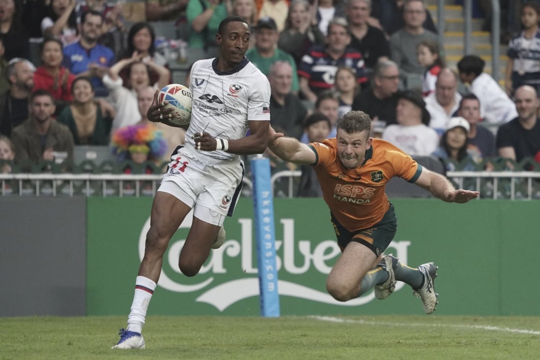 Perry Baker breaks clear of Australia’s Hayden Sargeant to score one of his two tries. Photo: AP