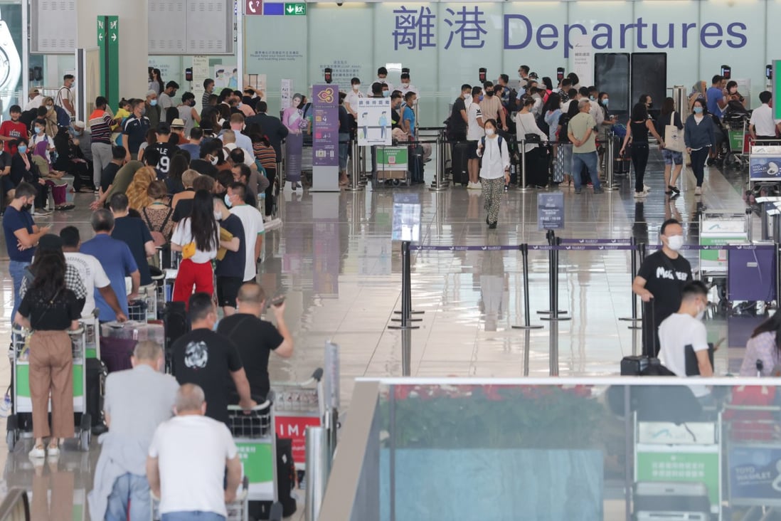 Passengers queue in the departures hall at Hong Kong International Airport on September 21, 2022. The city’s challenge in the face of its latest wave of emigration is to restore a favourable environment at home and give its talented young people a reason to stay. Photo: Jelly Tse