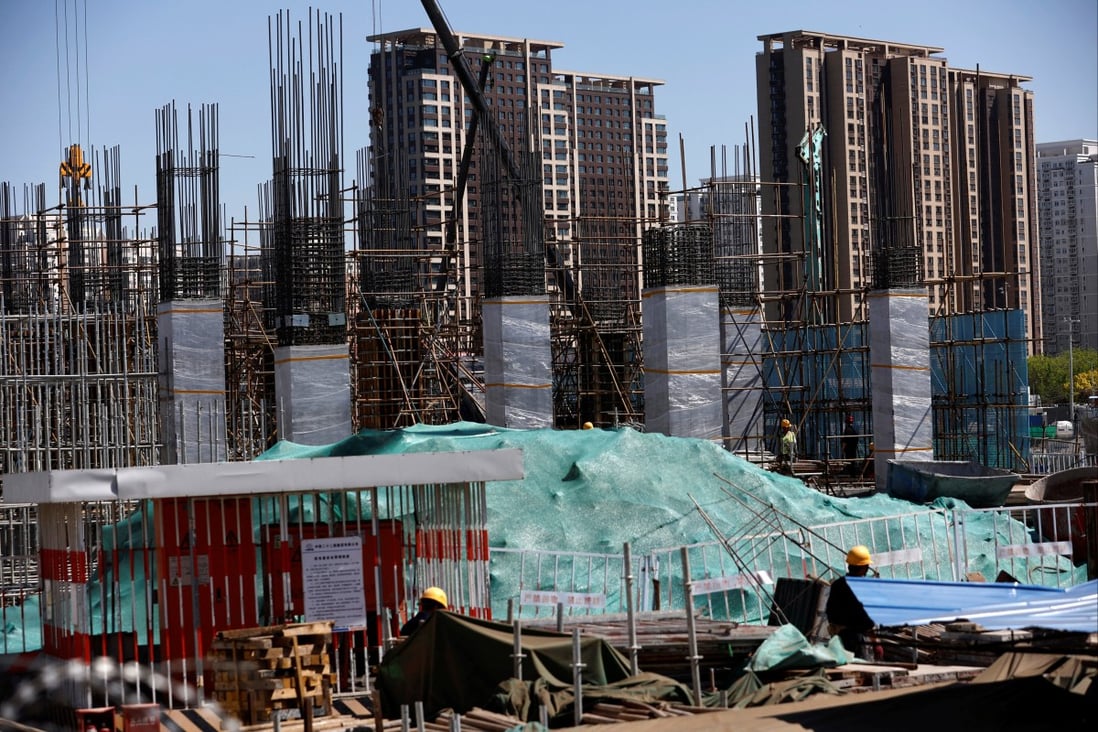 New homes stand behind the construction site of a new subway station in Beijing on April 18, 2023. Photo: Reuters