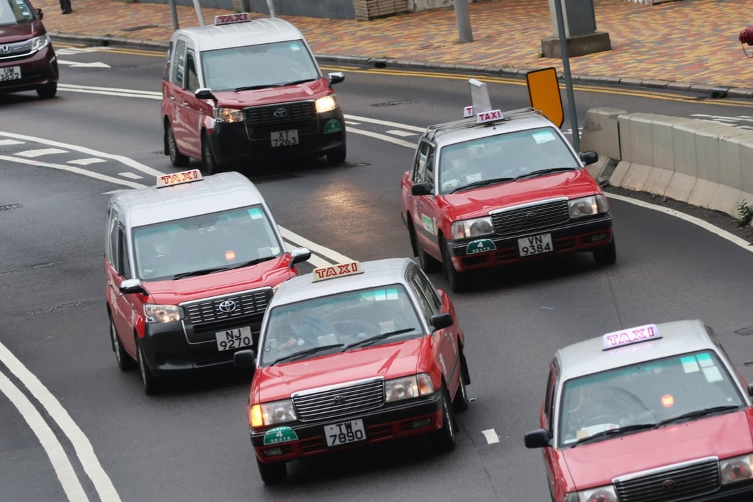 Hong Kong high-tech taxis equipped with advanced driver monitoring systems and electronic payment methods are seen driving on the road in 2025.