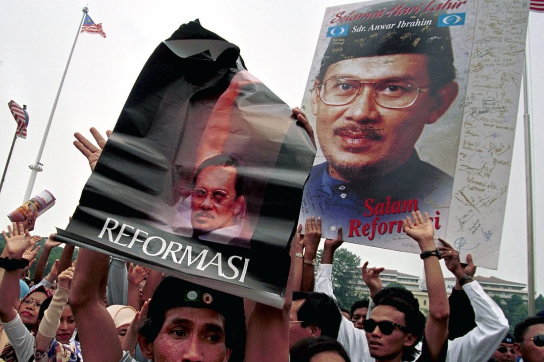 Supporters of Anwar Ibrahim, Malaysia ousted deputy prime minister, hold “Reformasi” posters during a rally in August 1999 in Kuala Lumpur. File photo: AP