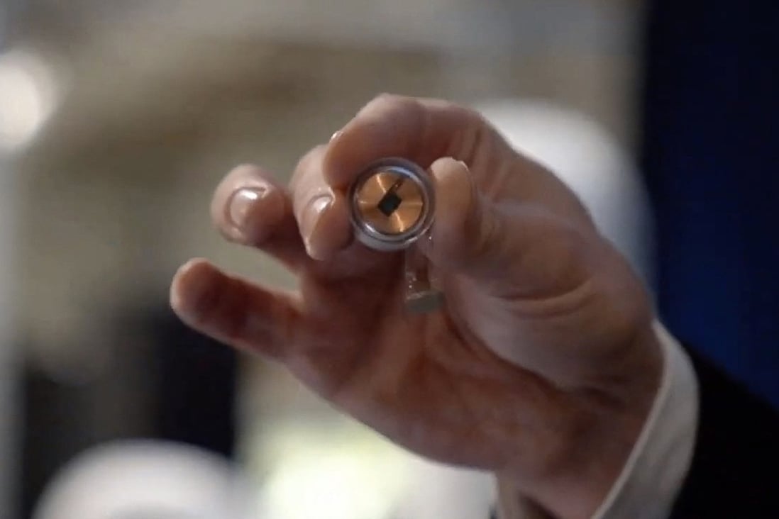 A Neuralink disk implant held by Elon Musk during a 2020 presentation. File photo: Neuralink via AFP