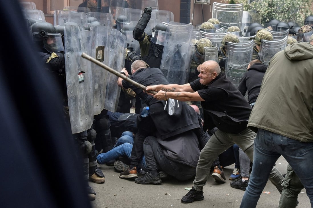 Nato Kosovo Force (KFOR) soldiers clash with local Serb protesters at the entrance of the municipality office in the town of Zvecan on Monday. Photo: Reuters