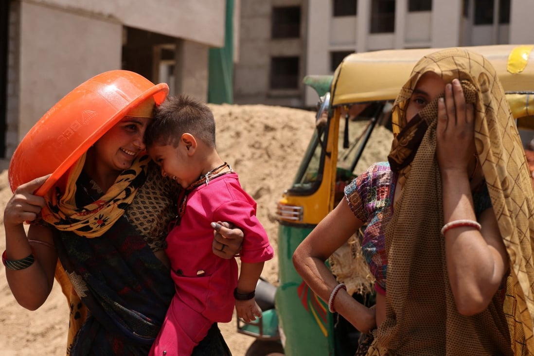 Women take shelter from the sun at a construction site in Ahmedabad, India, on April 28. Photo: Reuters