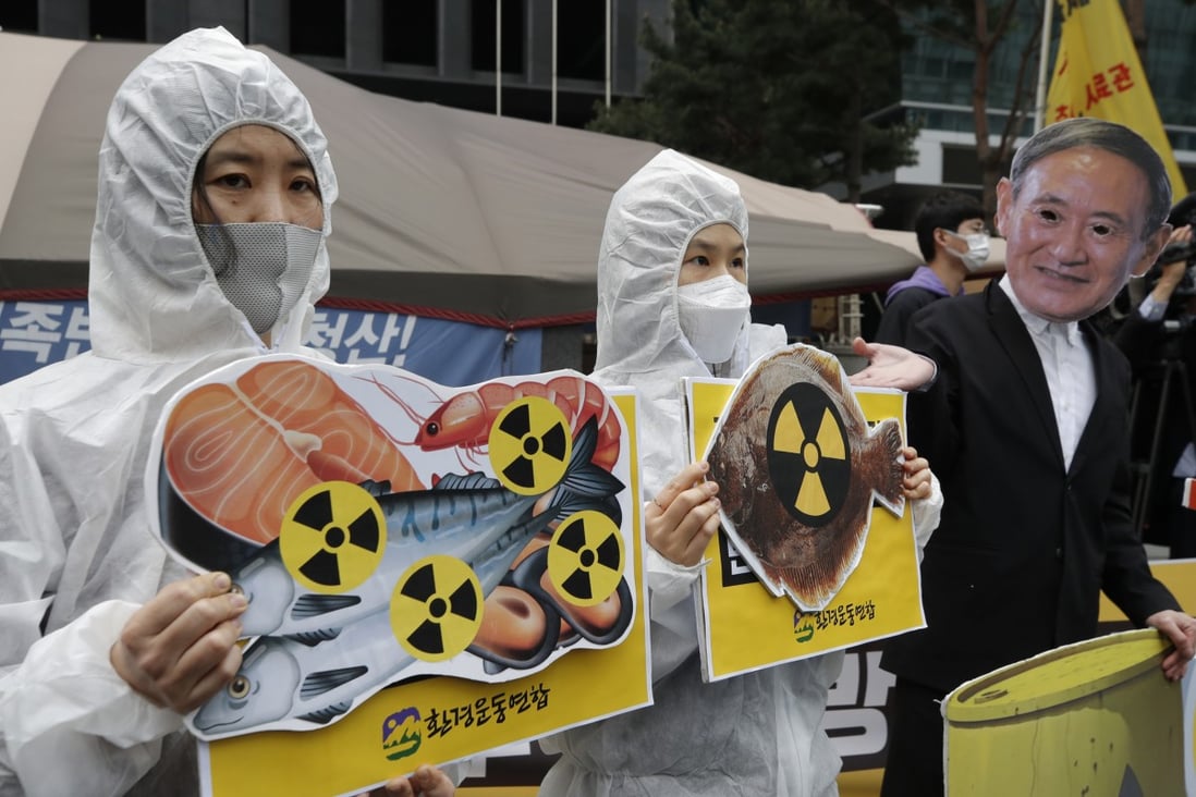 Environmental activists denounce the Japanese government’s plan to start releasing treated radioactive water from the wrecked Fukushima nuclear plant into the Pacific Ocean. Photo: AP
