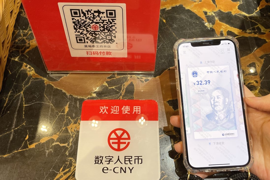 A customer makes a payment using China’s digital yuan, or e-CNY, at the Wangfujing Department Store in Beijing. Central bank digital currencies allow central banks to retain control while providing a financial system that avoids scams. Photo: Getty Images