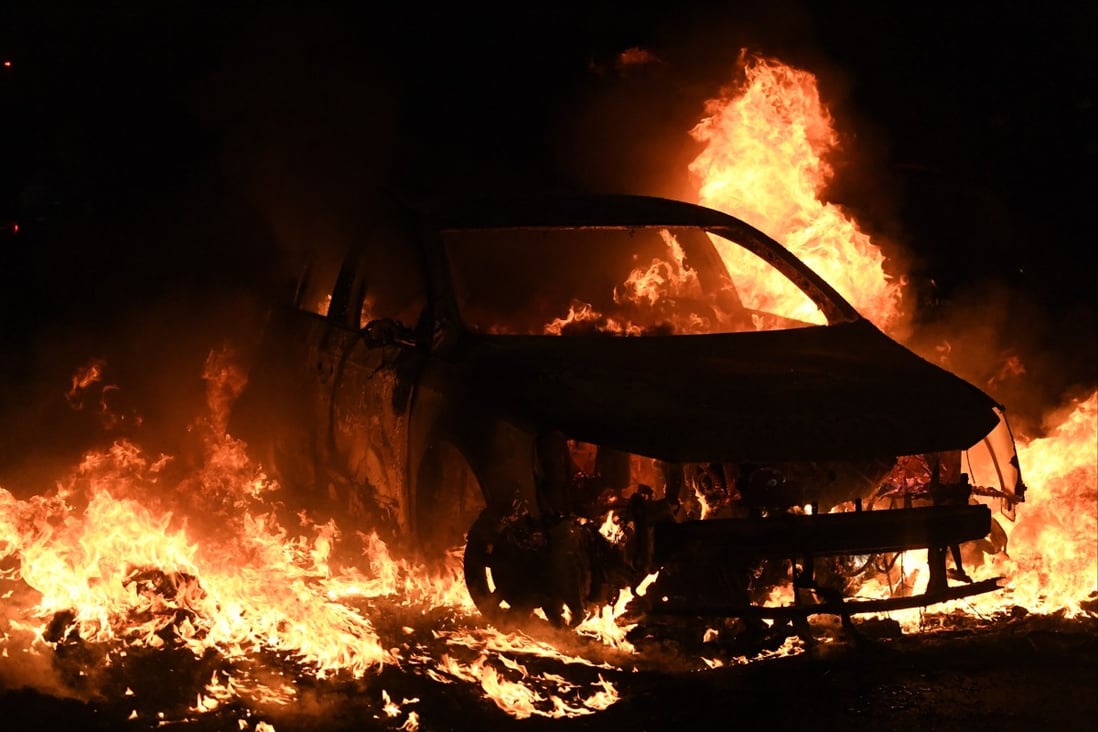 A car burns during clashes between protesters and riot police in Nanterre, near Paris, on Thursday. Photo: EPA-EFE